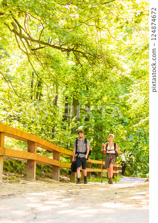 couple backpacker hiking in forest pathway couple backpacker hiking in forest pathway 124874672