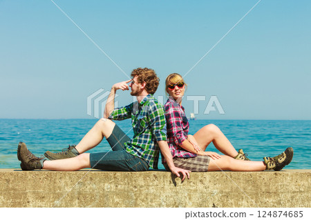 hiking couple relaxing on sea coast 124874685