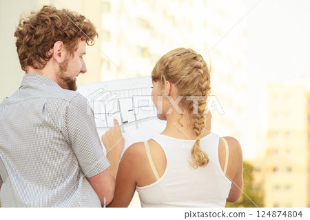 couple with blueprint project building plans outdoor couple with blueprint project building plans outdoor 124874804