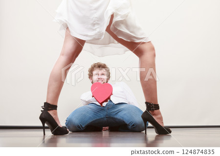 Man with heart shaped gift box for woman. Man with heart shaped gift box for woman. 124874835