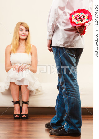 Man giving woman candy bunch flowers. Love. 124874850