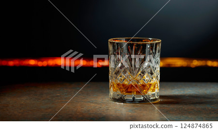 Glass of whiskey on a dark background. Glass of whiskey on a dark background. 124874865