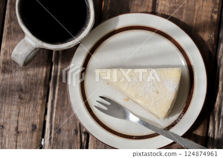 Rare cheesecake and black coffee on a plate 124874961