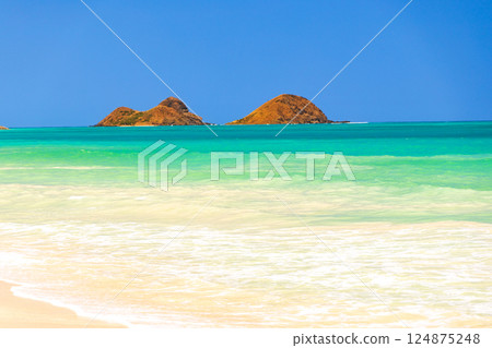 Hawaiian Holidays: Mokulua Islands as seen from Bellows Beach on Oahu Hawaiian Holidays: Mokulua Islands as seen from Bellows Beach on Oahu 124875248