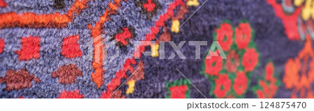 Manufacturing process, weaving of a traditional wool oriental red carpet with an intricate floral pattern, decorative elements. banner Manufacturing process, weaving of a traditional wool oriental red carpet with an intricate floral pattern, decorative elements. banner 124875470