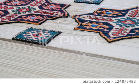 Manufacturing process, weaving of a traditional wool oriental blu carpet with an intricate floral pattern, decorative elements Manufacturing process, weaving of a traditional wool oriental blu carpet with an intricate floral pattern, decorative elements 124875488