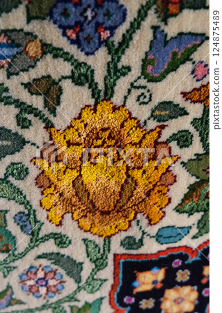 Manufacturing process, weaving of a traditional wool oriental red carpet with an intricate floral pattern, decorative elements Manufacturing process, weaving of a traditional wool oriental red carpet with an intricate floral pattern, decorative elements 124875489