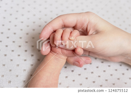 Newborn baby feet. Motherhood concept. Mother day. Copy space. Selective focus Newborn baby feet. Motherhood concept. Mother day. Copy space. Selective focus 124875512