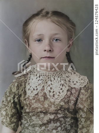Vintage portrait of a serious little girl with freckles. Retro photo from 1949. 124876428