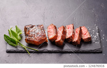 A perfectly cooked sliced striploin steak with a juicy, tender texture 124876916