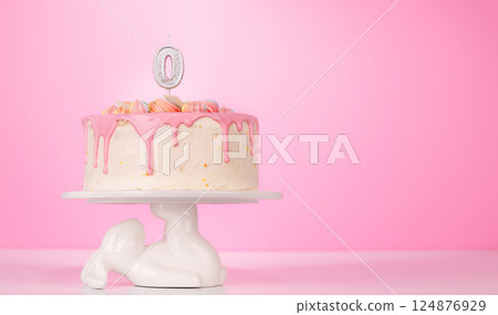 A festive birthday cake topped with candle A festive birthday cake topped with candle 124876929