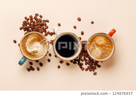 A steaming cups of freshly brewed coffee surrounded by rich, aromatic roasted coffee beans A steaming cups of freshly brewed coffee surrounded by rich, aromatic roasted coffee beans 124876937