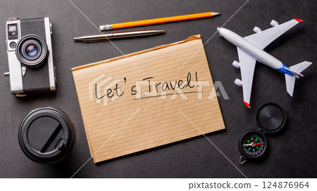 Creative flat lay of a travel-themed desk with notepad for plans Creative flat lay of a travel-themed desk with notepad for plans 124876964