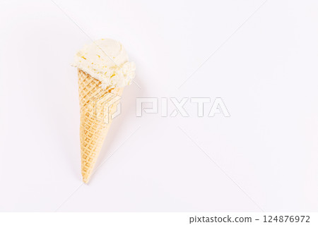 A refreshing ice cream cone set against a white background A refreshing ice cream cone set against a white background 124876972