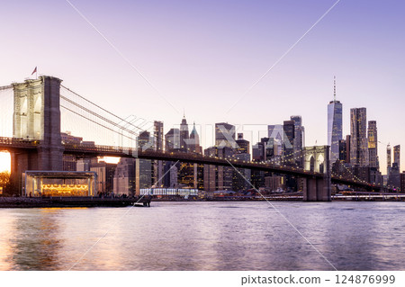 A panoramic sunset view of the Brooklyn Bridge stretching towards Manhattan A panoramic sunset view of the Brooklyn Bridge stretching towards Manhattan 124876999