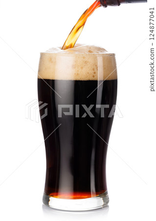 A tall glass of dark stout beer with frothy head, isolated on a clean white background 124877041