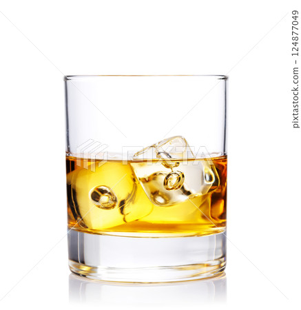 A classic whiskey glass filled with golden amber whiskey 124877049