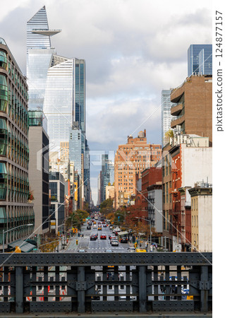 Captivating view of a bustling NYC Downtown street framed by iconic Manhattan skyscrapers 124877157