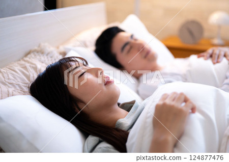 Men and women sleeping side by side Men and women sleeping side by side 124877476