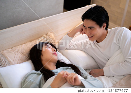 Man and woman having a conversation in bed Man and woman having a conversation in bed 124877477
