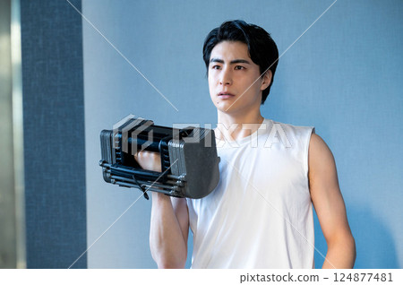 Man doing muscle training with dumbbells 124877481