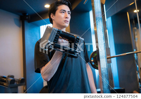 Man doing muscle training with dumbbells 124877504
