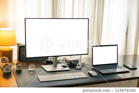 Desktop and laptop computers on a home desk, mockup screen Desktop and laptop computers on a home desk, mockup screen 124878200