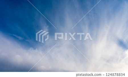 Thin clouds in the blue sky at dusk Thin clouds in the blue sky at dusk 124878834