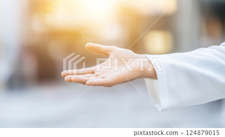 Hand of Jesus reaching out with light in spiritual scene, copy space background 124879015