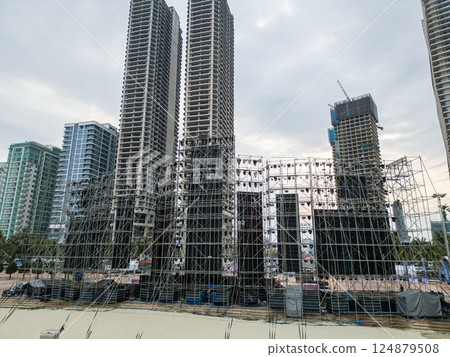 Massive Stage Setup with Scaffolding and Lighting for Urban Event, Detailed View of Expansive Stage Structure with Rigging and Illumination for City Festival 124879508