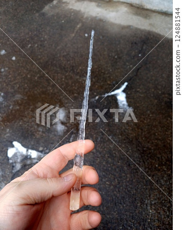 Icicle in a man's hand 124881544