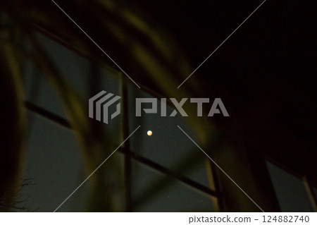 Looking at a Total Lunar Eclipse Through a Window 124882740