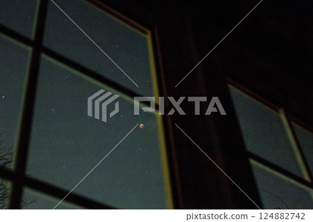 Looking at a Total Lunar Eclipse Through a Window 124882742