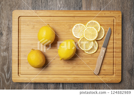 whole lemons and lemon wedges 124882989