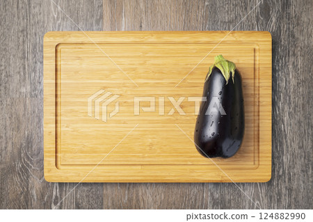 ripe eggplant on wooden board 124882990