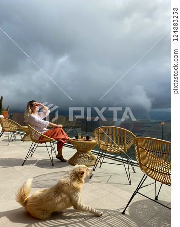 Beautiful woman relaxing on the terrace of a cafe Beautiful woman relaxing on the terrace of a cafe 124883258