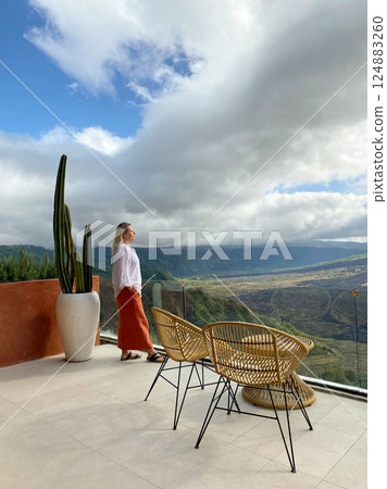 Beautiful woman relaxing on the terrace of a cafe Beautiful woman relaxing on the terrace of a cafe 124883260