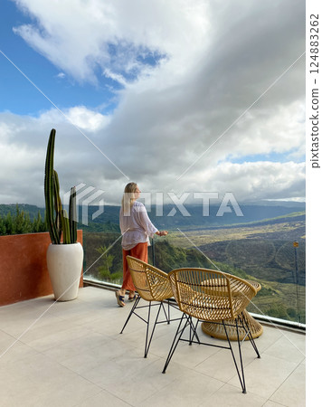 Beautiful woman relaxing on the terrace of a cafe 124883262