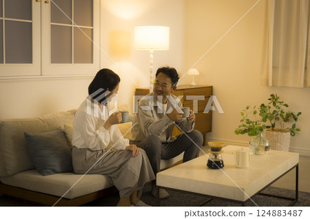 Middle-aged couple in the living room at night Middle-aged couple in the living room at night 124883487