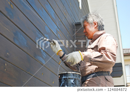 Man painting the exterior of a log house, Part 5 Man painting the exterior of a log house, Part 5 124884872