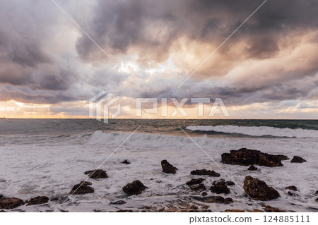 Beautiful landscape, storm on the sea and sunset sky with clouds Beautiful landscape, storm on the sea and sunset sky with clouds 124885111