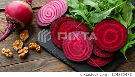Beautiful spiral tower with salad and red onions set against modern buildings in an urban landscape 124885478