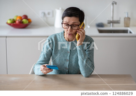 Scared woman transferring money accounts fraudsters phone deception identity theft financial scam 124886029