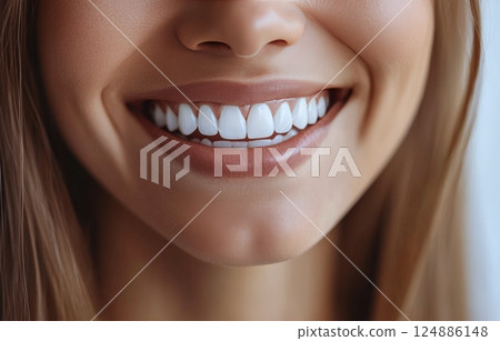 Bright smile of a young woman showcasing healthy teeth and beautiful freckles in casual setting 124886148