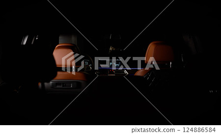 Modern car interior showing infotainment system and leather seats at night Modern car interior showing infotainment system and leather seats at night 124886584