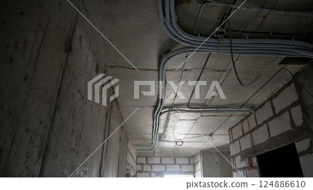 Electrical conduit wiring installation in building under construction Electrical conduit wiring installation in building under construction 124886610