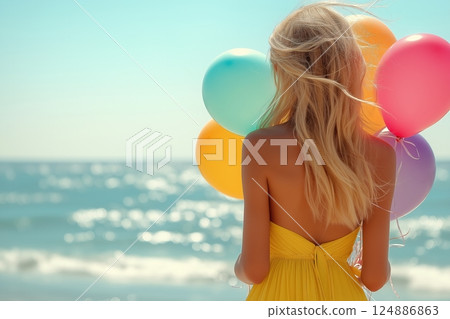 Young woman with balloons at the beach enjoying a sunny day 124886863