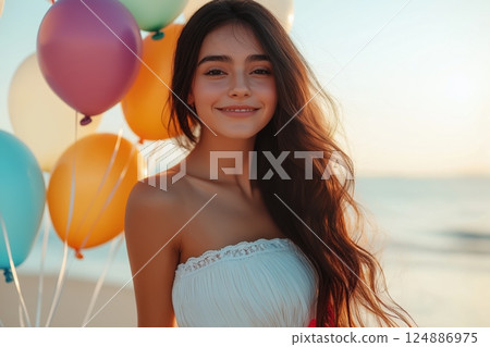 Smiling young woman with colorful balloons at beach during sunset Smiling young woman with colorful balloons at beach during sunset 124886975