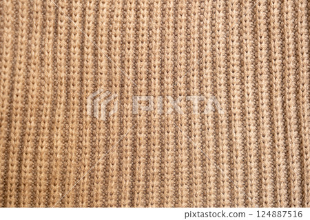 knitted texture, beige sweater or carpet. English elastic band pattern. industrial knitting. knitted texture, beige sweater or carpet. English elastic band pattern. industrial knitting. 124887516