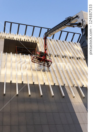 Construction crews and installers of high-rise buildings install fittings or lay electrical wiring 124887533